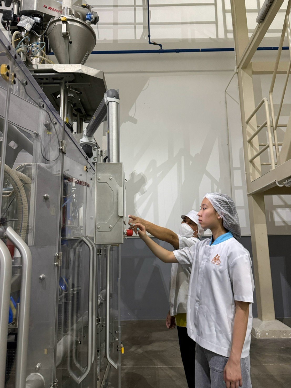 Winnie operating an automated packaging machine