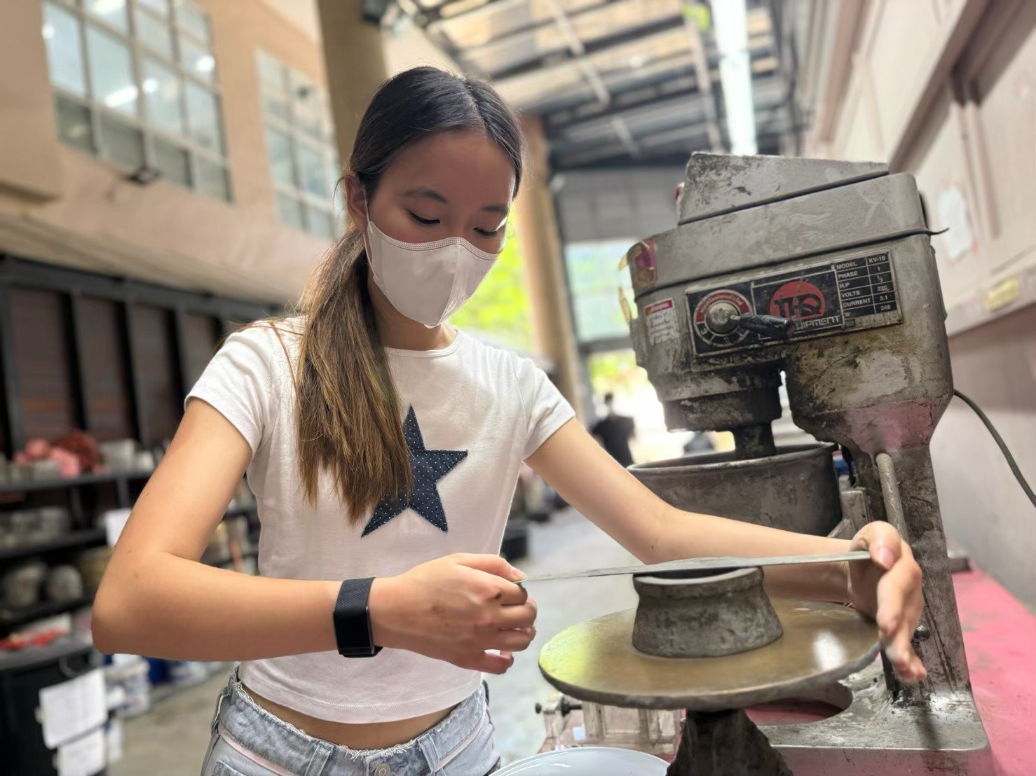 Winnie levelling a mortar sample on the flow table